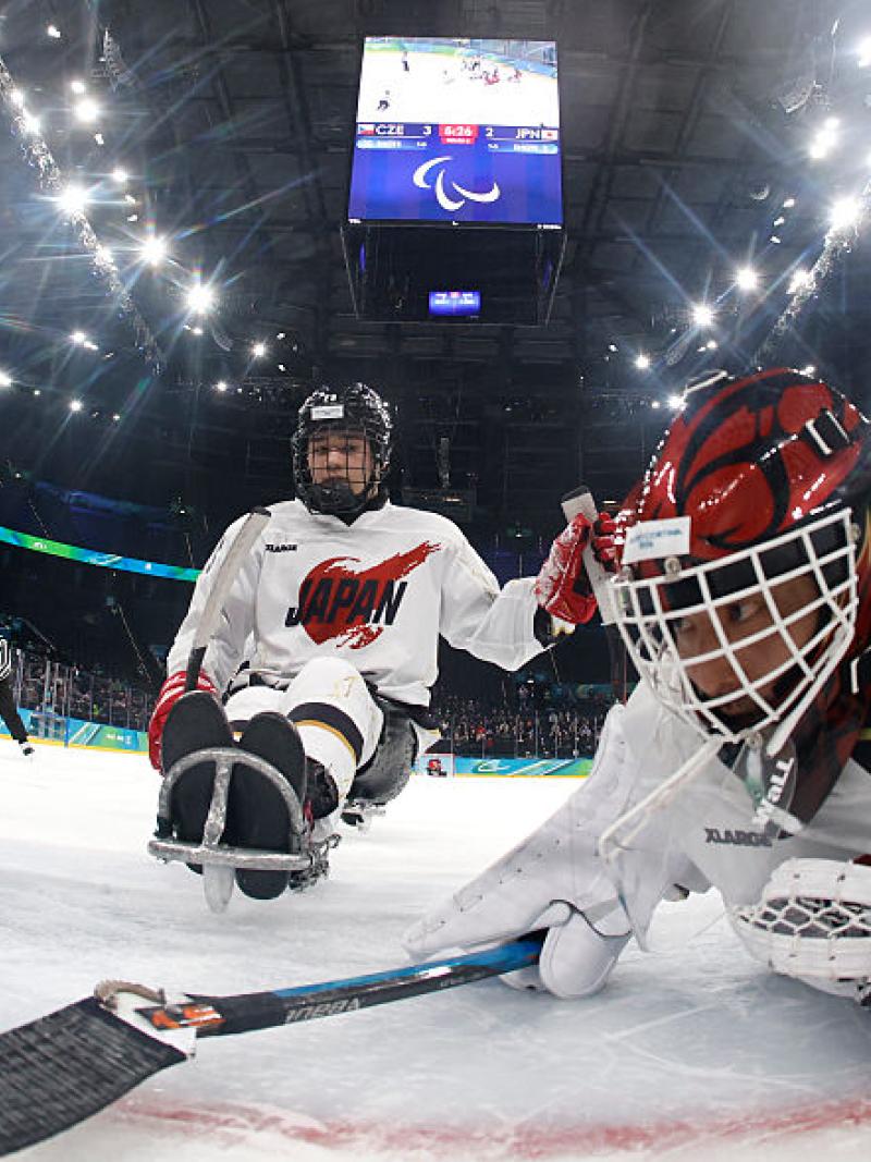 A goaltender trying to avoid the puck crossing the goal line