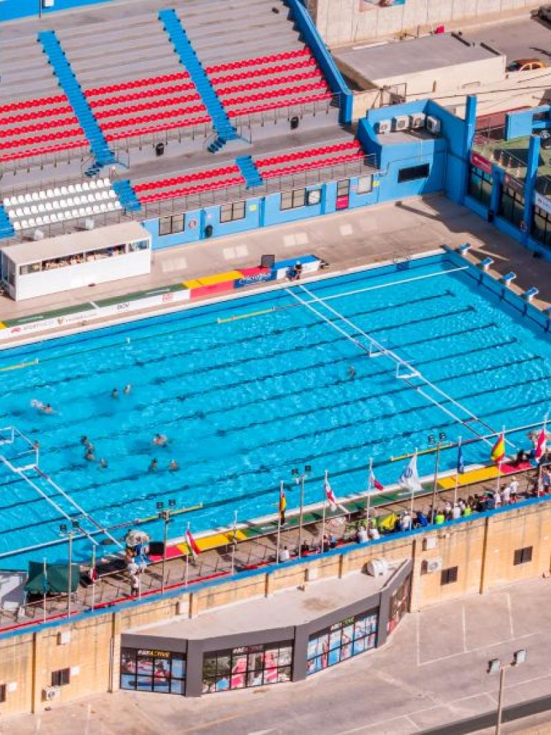An aerial view of an outdoor competition swimming pool