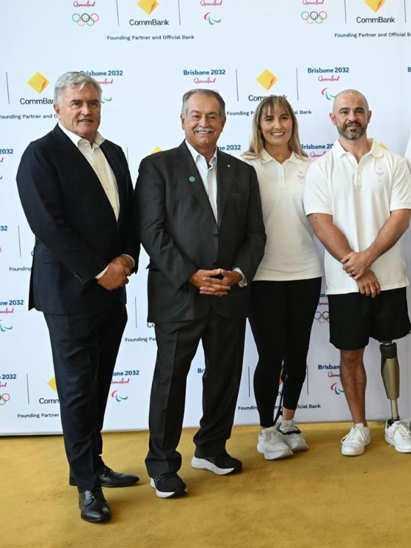 Eleven people stand in a line for a picture