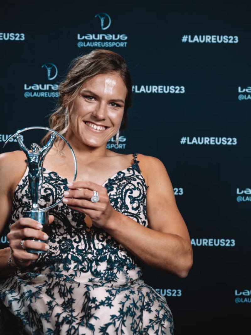A woman in a wheelchair showing her Laureus Sports Awards statuette