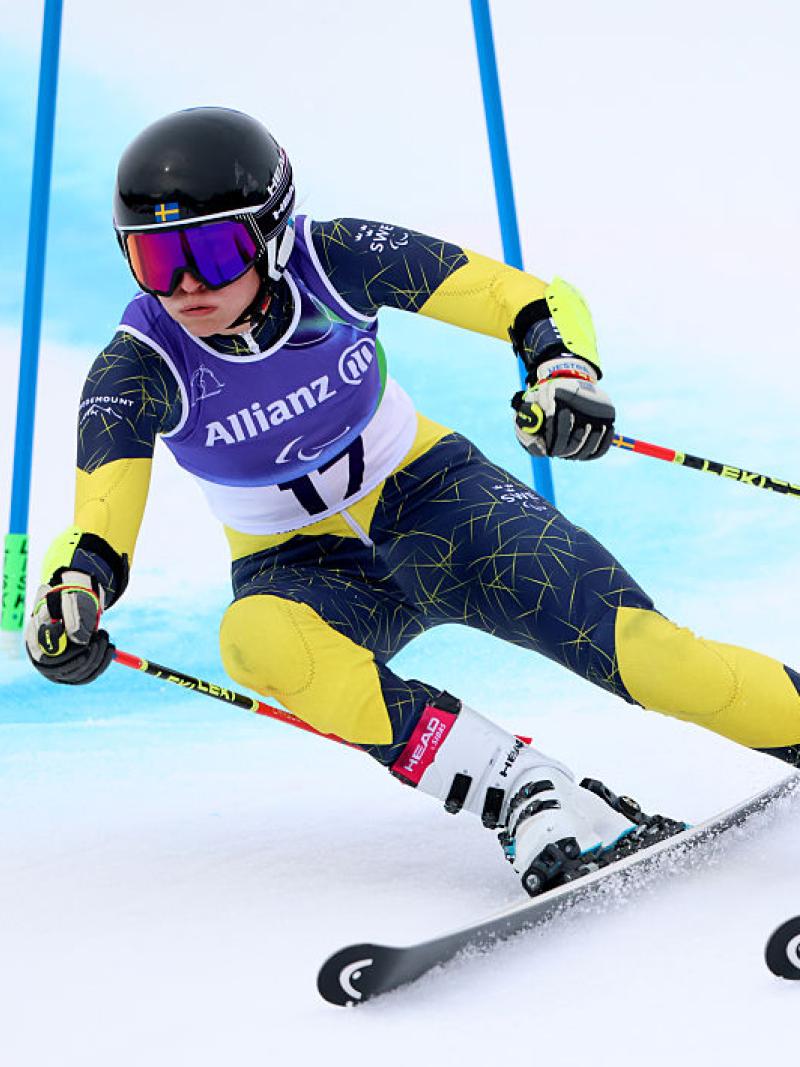 A female Para alpine skiing athlete is in action at the Milano Cortina 2026 Paralympics