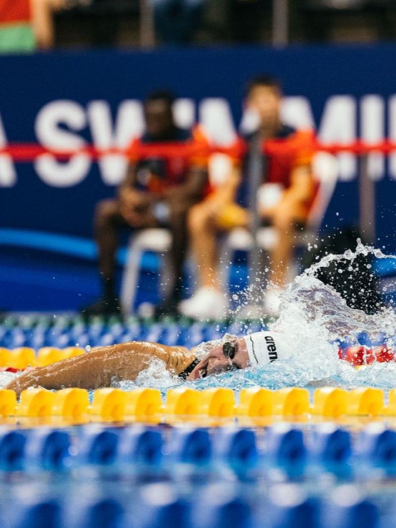 A female swimmer in a freestyle competition