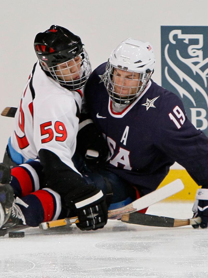 Noritaka Ito and Taylor Chace battling for the puck.