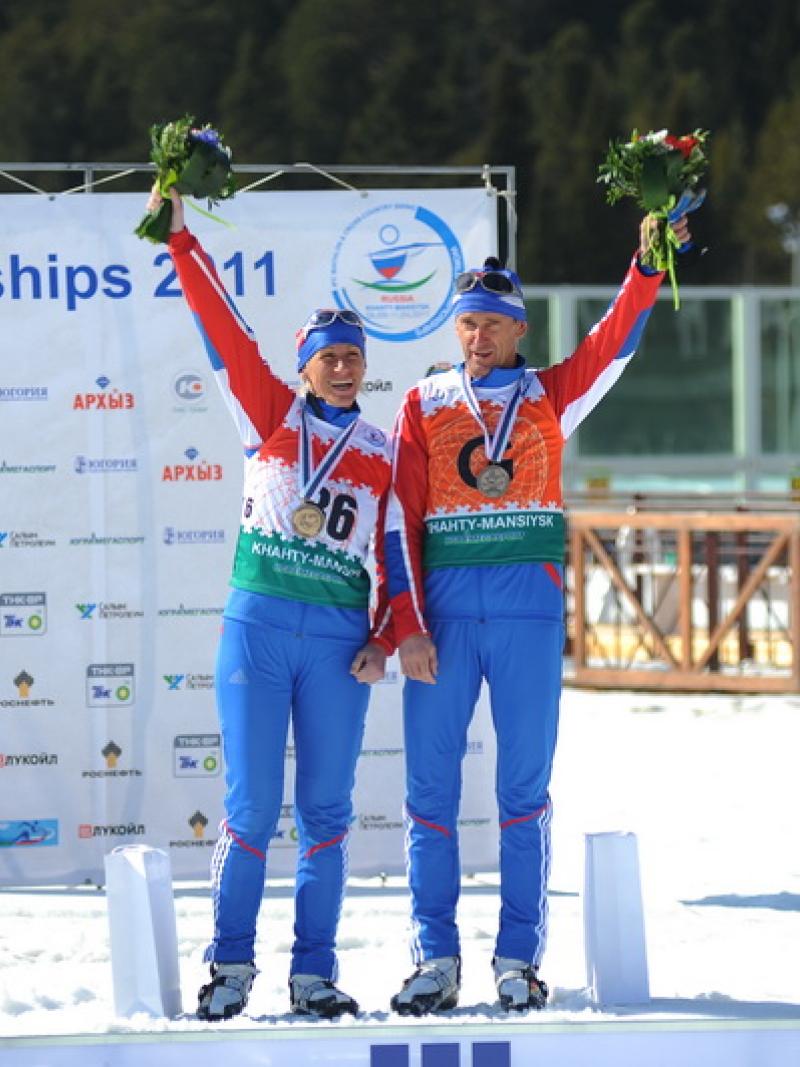Skier on the podium with her guide