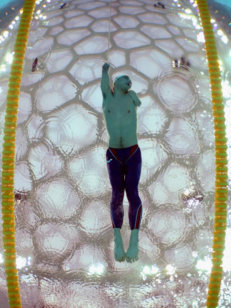 Underwater shot in a swimming pool. A swimmer is photographed from below.