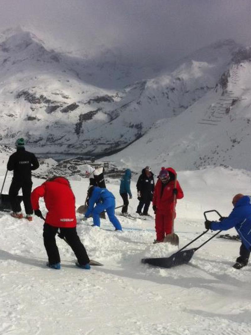 Coaches working hard on the slope to prepare for the race.