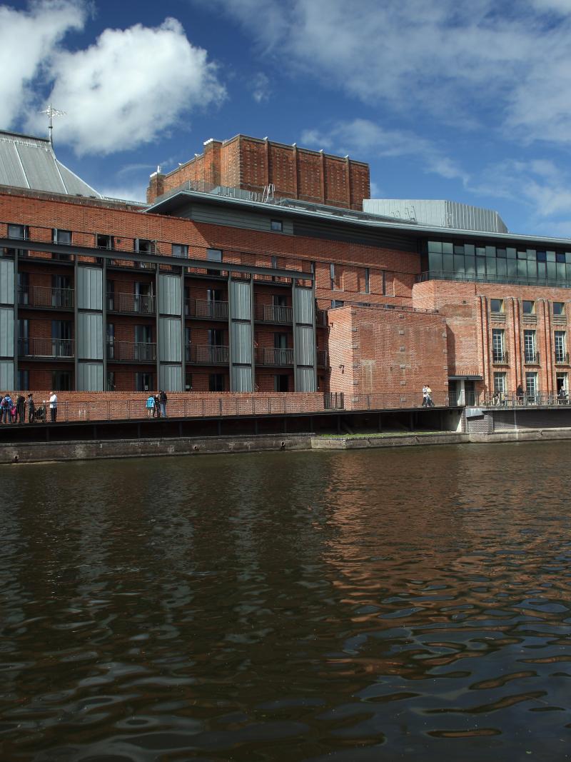 A picture of a building next to a river