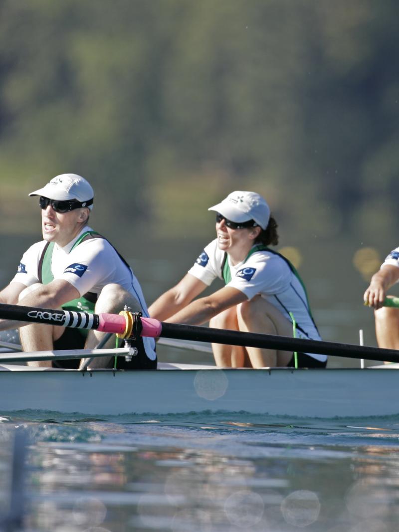 A picture of four people rowing