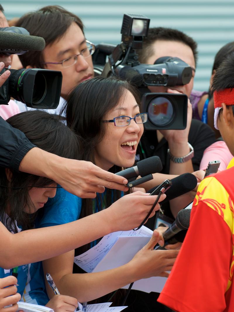 A picture of plenty of journalists trying to interview a 5-a-side football player.