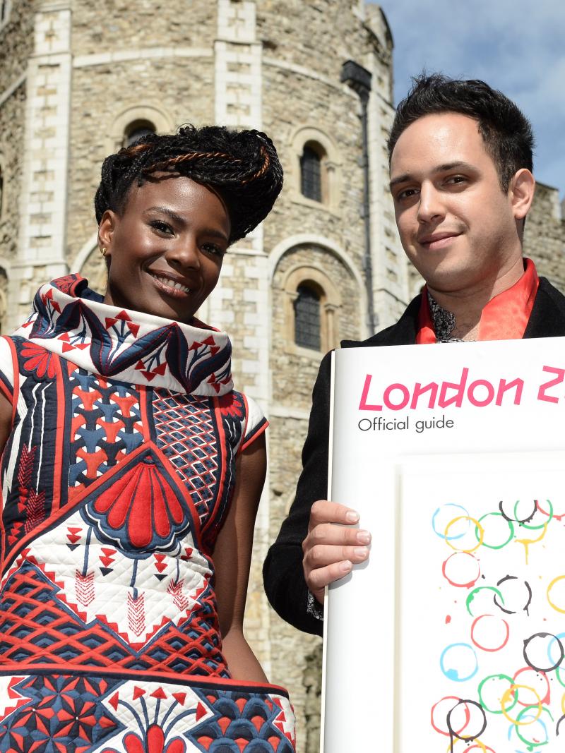 A picture of 2 standing people in front of a castle showing the London 2012 festival Official Guide.