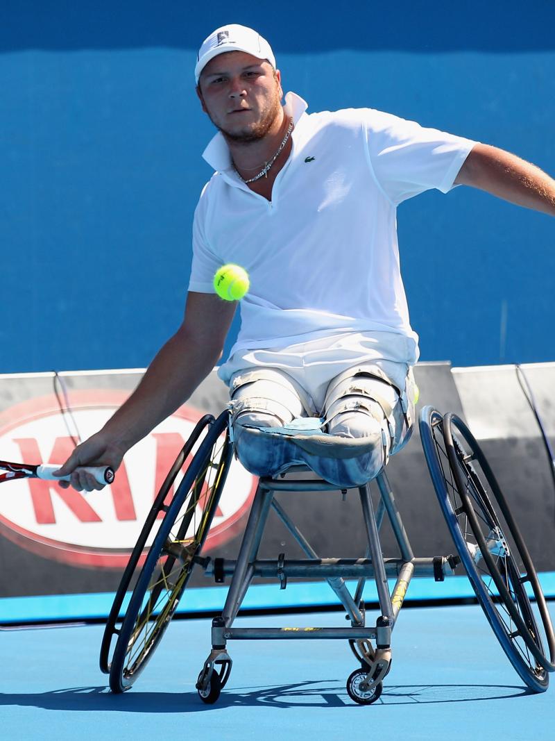 A picture of a man in a wheelchair playing tennis