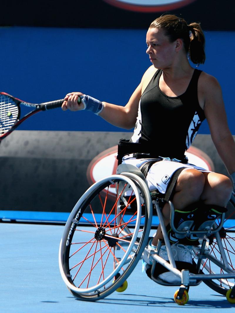 A picture of a girl in a wheelchair playing tennis