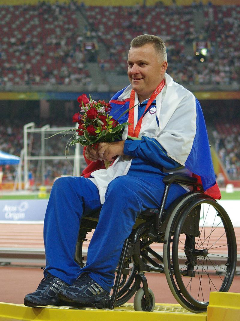 A picture of a man in a wheelchair during a medal ceremony