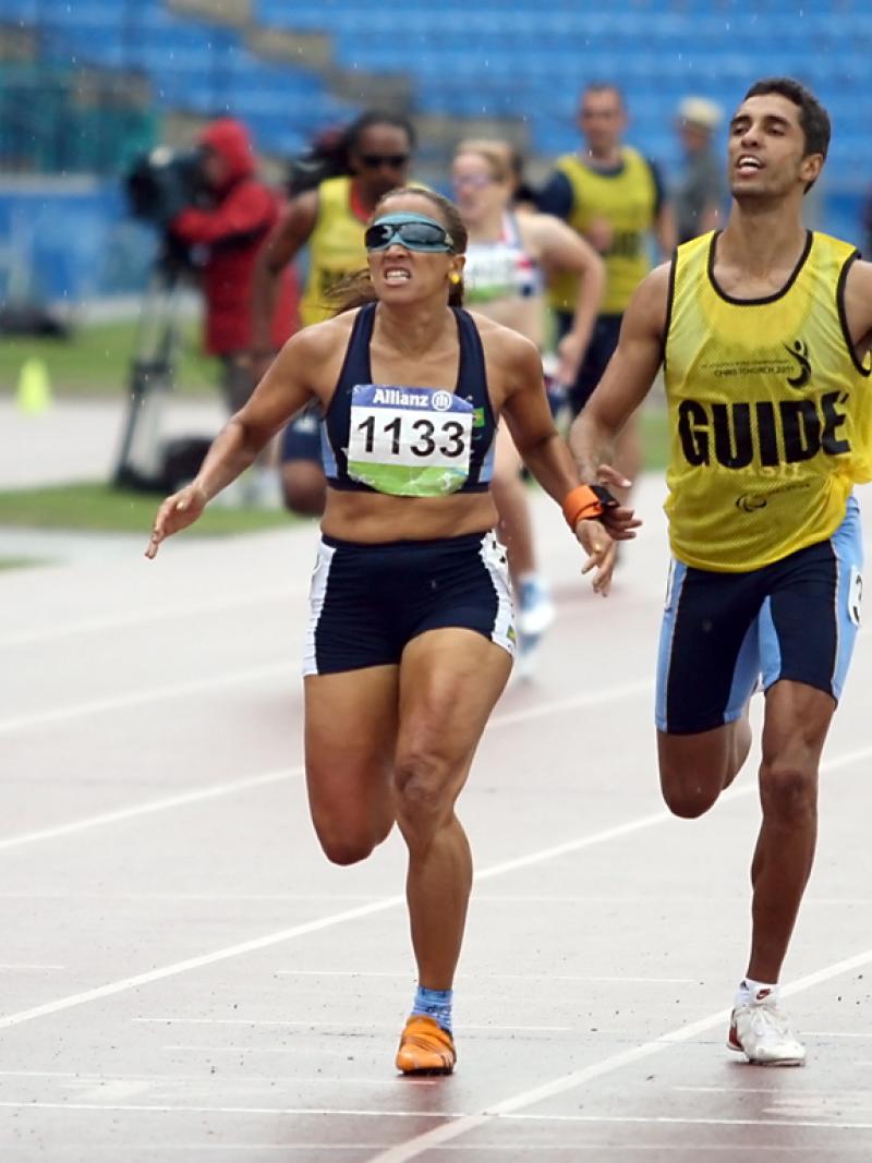 Terezinha Guilhermina running with guide