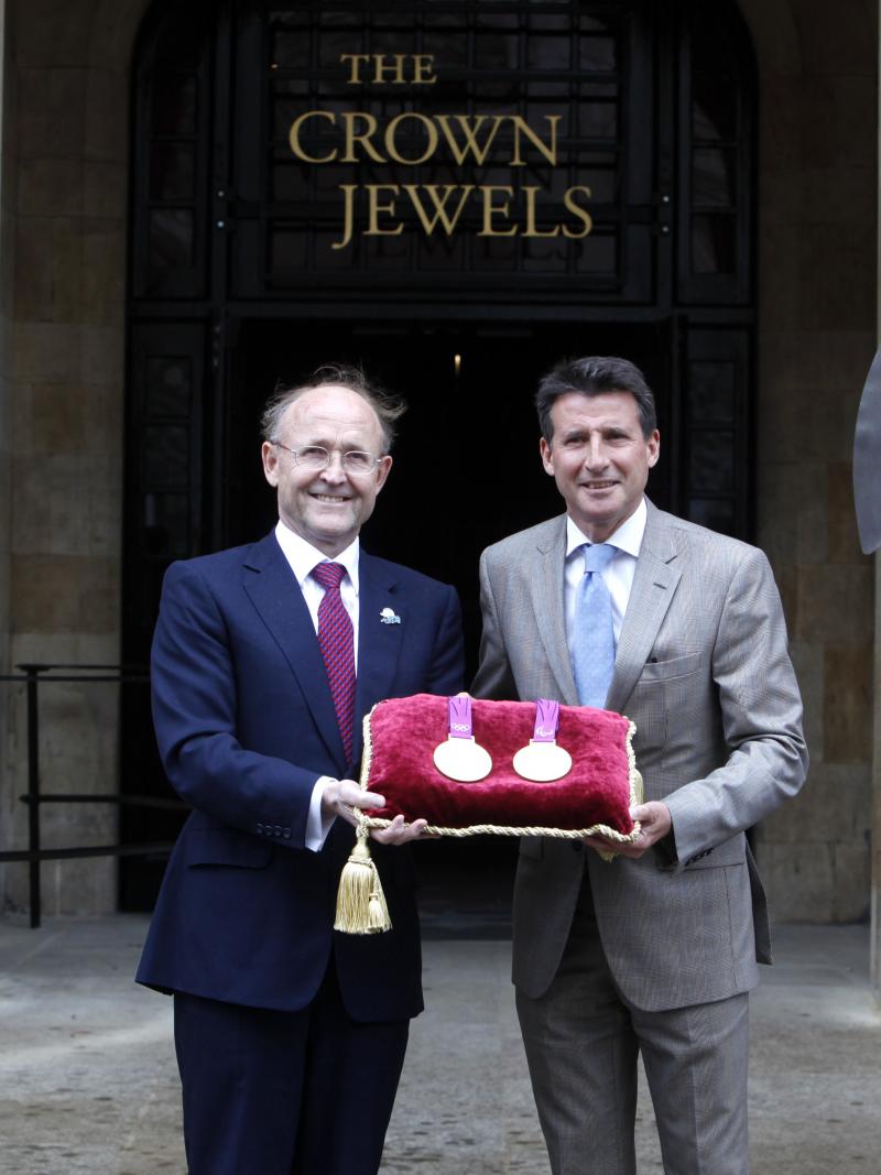 A picture of 2 men showing medals together