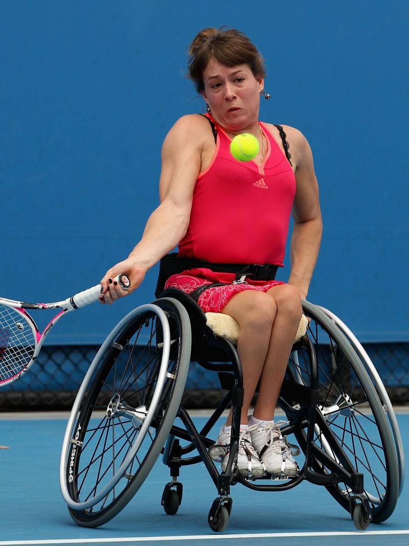 A picture of a woman in wheelchair playing tennis