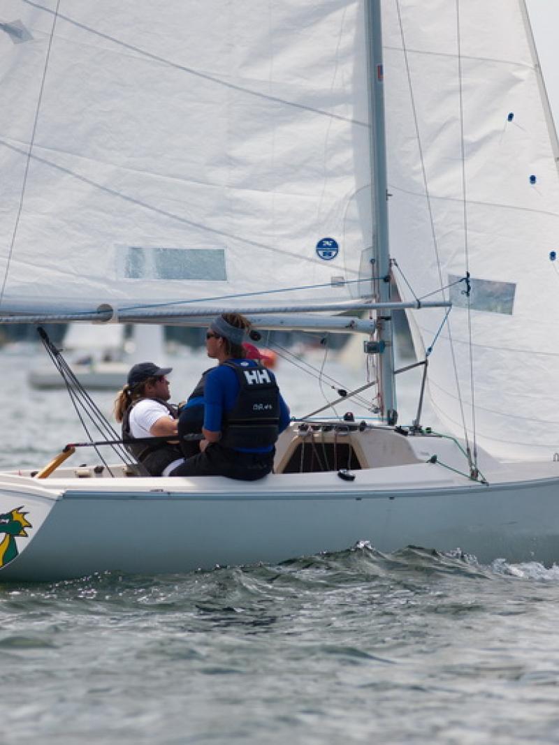 A picture of 3 persons in a boat