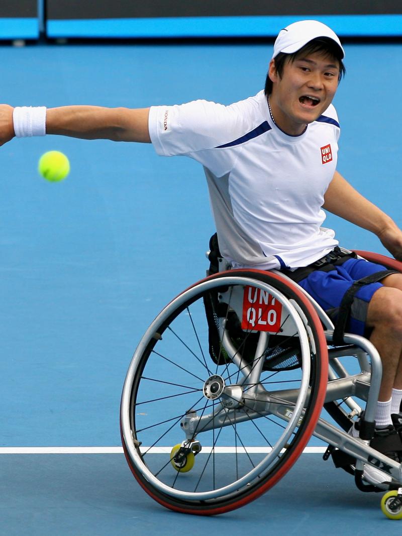A picture of a man in a wheelchair playing tennis