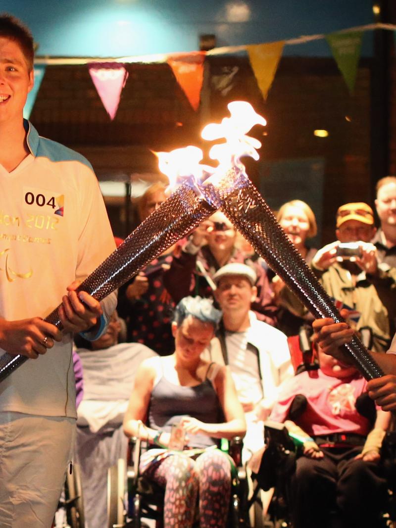 A picture of two person holding a torch