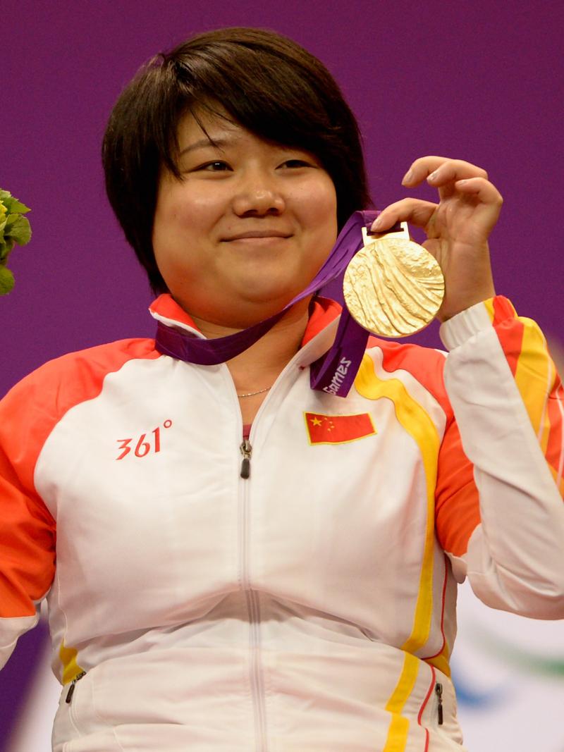 Zhang Cuiping celebrates with her gold medal