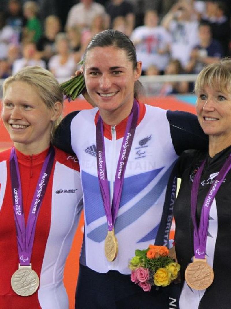 A picture of 3 womens on a podium