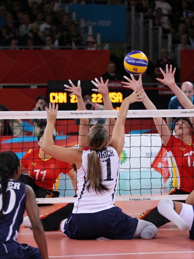 A picture of women playing Sitting Volleyball