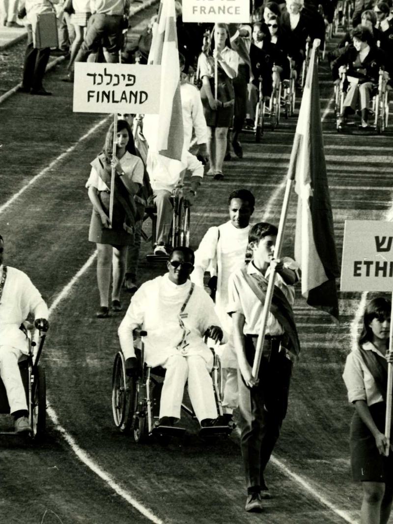 A picture of wheelchair athletes parade