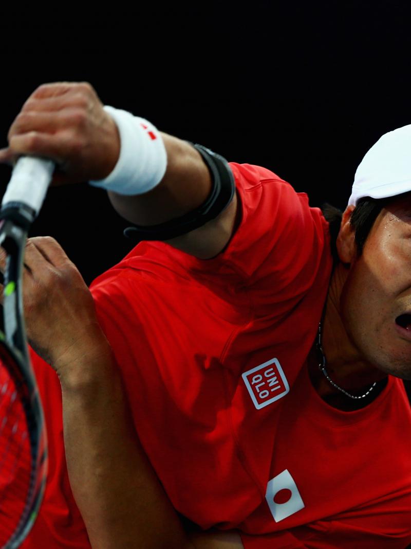 A picture of a man in a wheelchair playing tennis