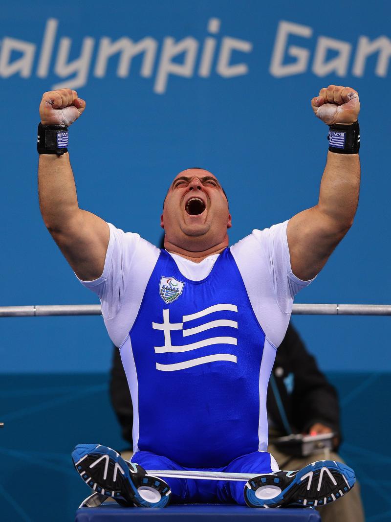 Pavlos Mamalos of Greece reacts with intense joy as he competes in the Men's -90 kg Powerlifting event.