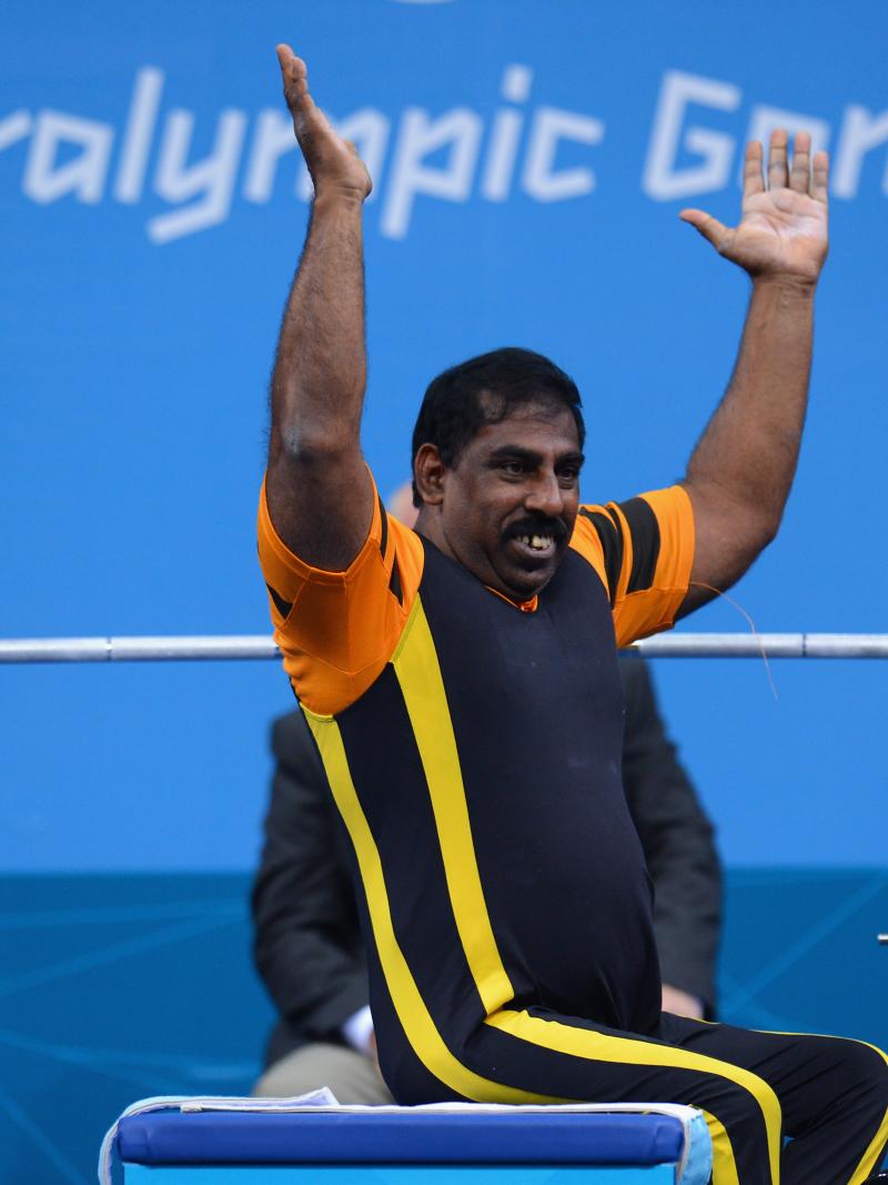 Mariappan Perumal of Malaysia waves to the crowd before he competes.