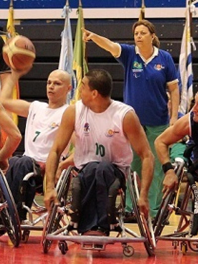 A picture of men in wheelchair playing basketball