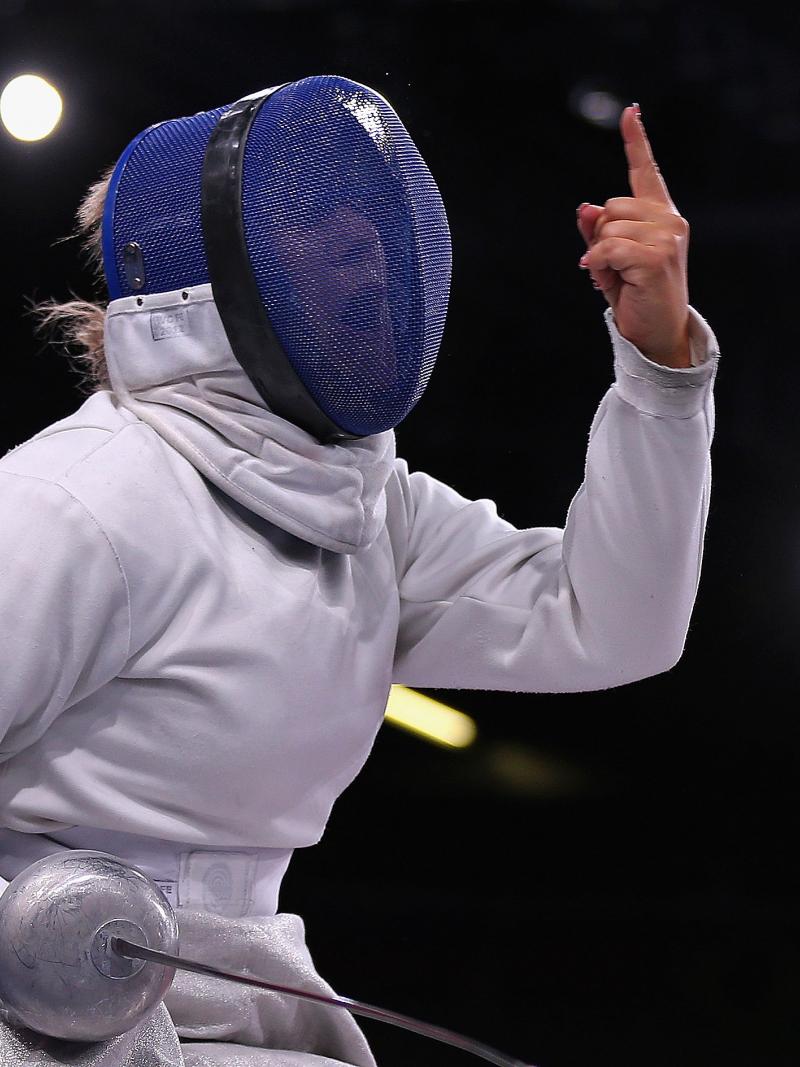 A picture of a Wheelchair Fencer celebrating her victory 