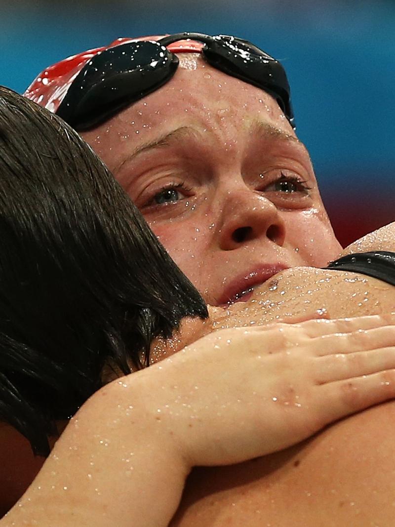 A picture of two women crying after their performances during a swimming race.