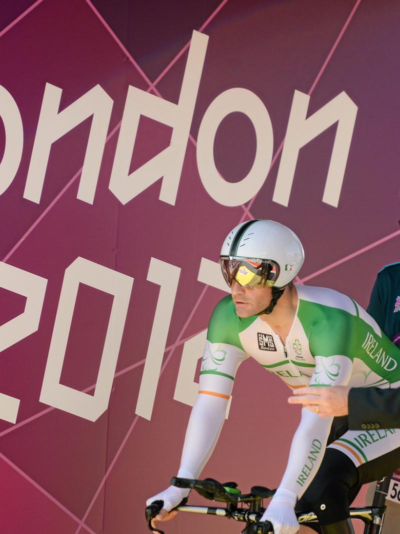 A picture of a man waiting for it's start during a para-cycling race.