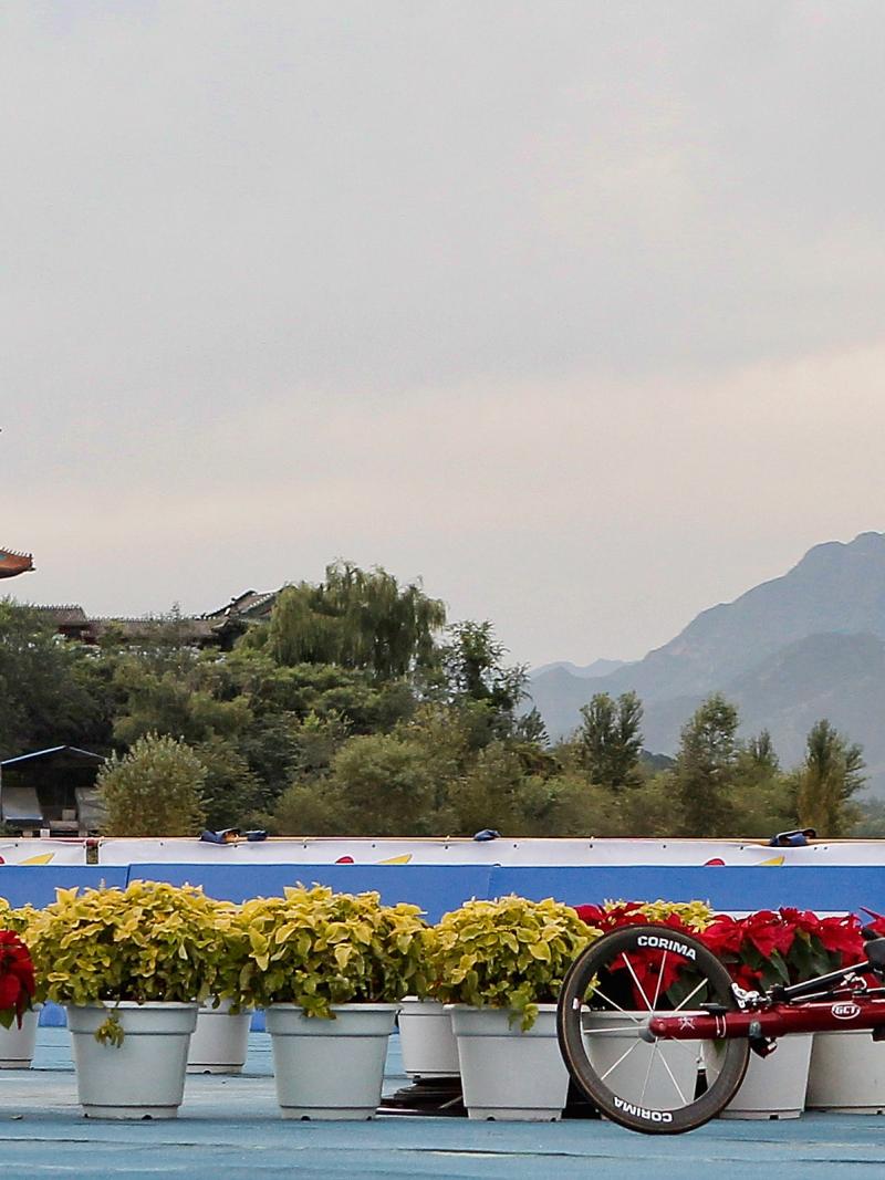 A picture of a man in a wheelchair racing.