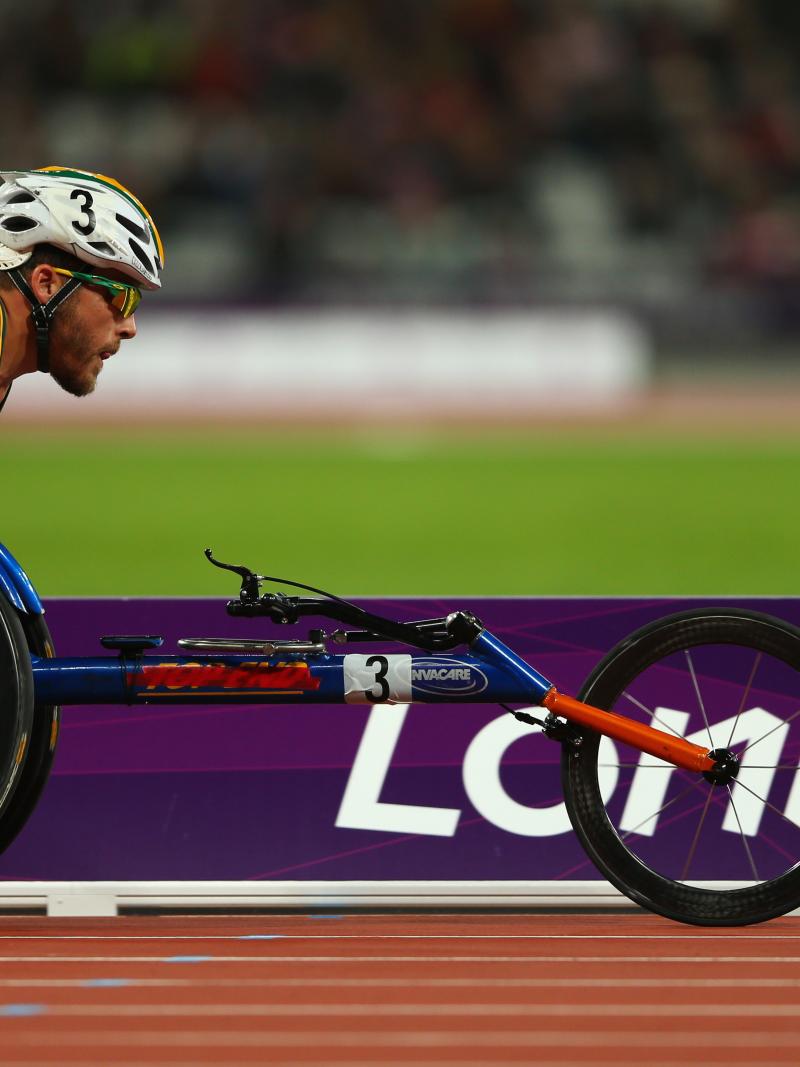 A picture of a man in a wheelchair racing during an athletics event