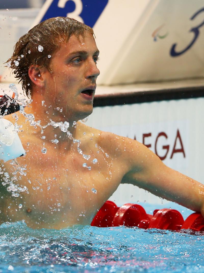 A picture of a man holding the swimming cap in his hand