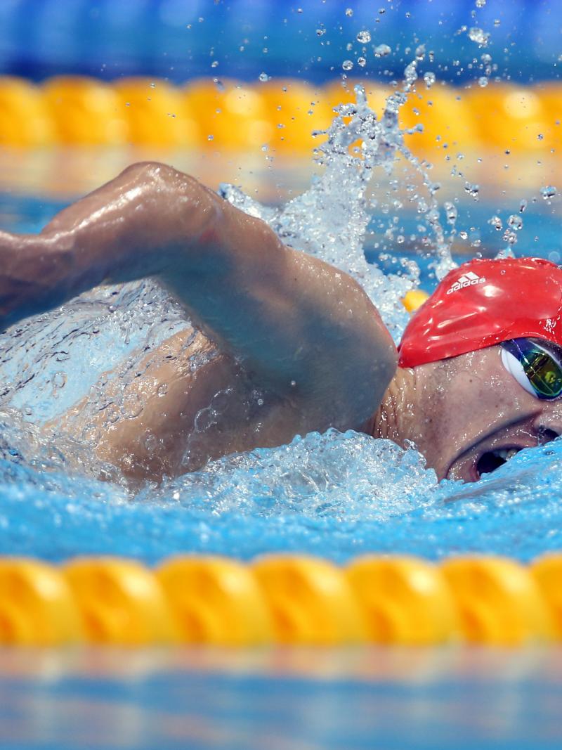 A picture of a man with the swimming cap in the pool