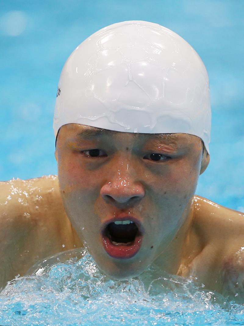 A picture of a man in the pool holding his head above the water