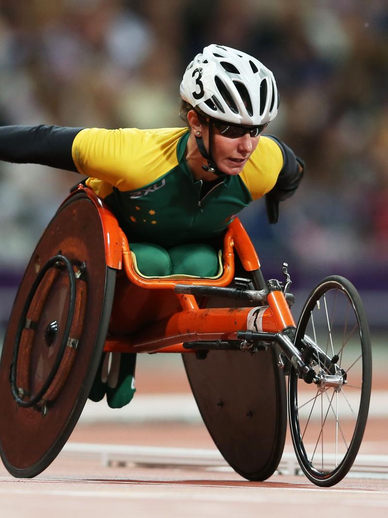 A picture of a woman in a wheelchair during a wheelchair race