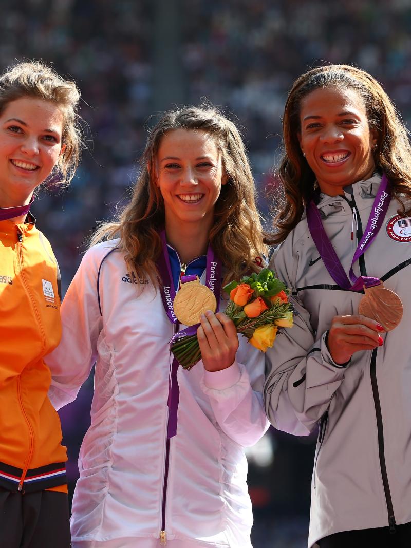 A picture of women on a podium with medals around their neck