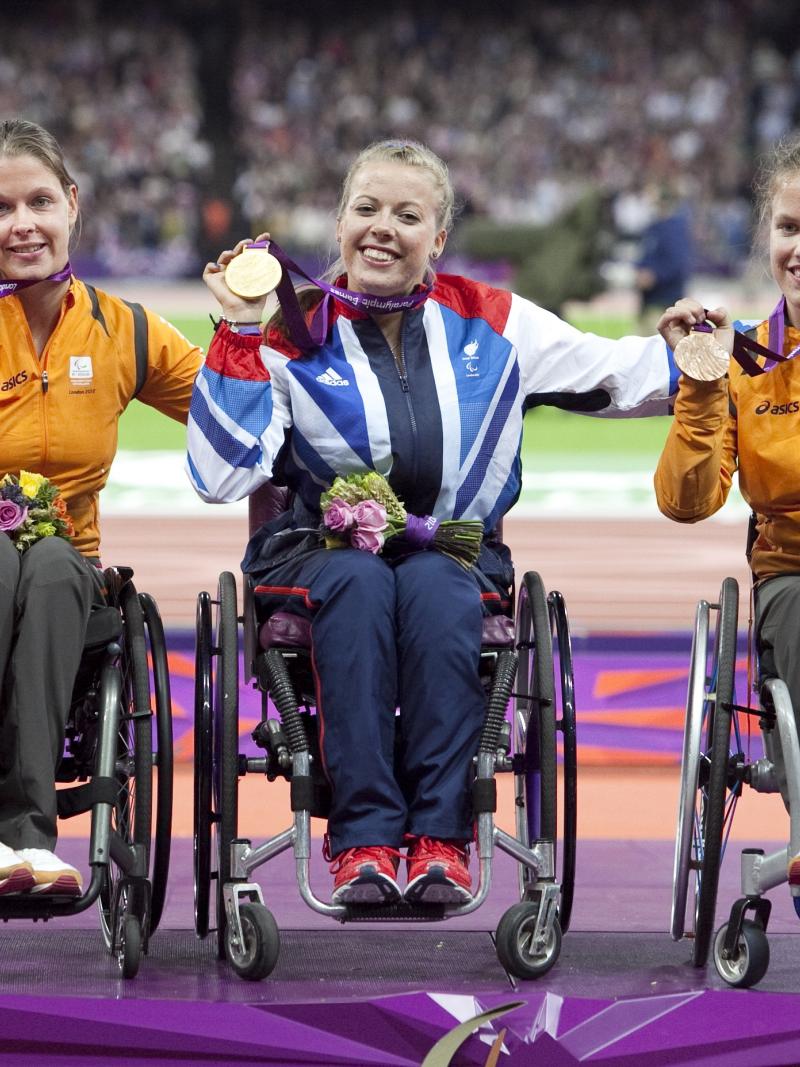 A picture of women on a podium with medals around their neck