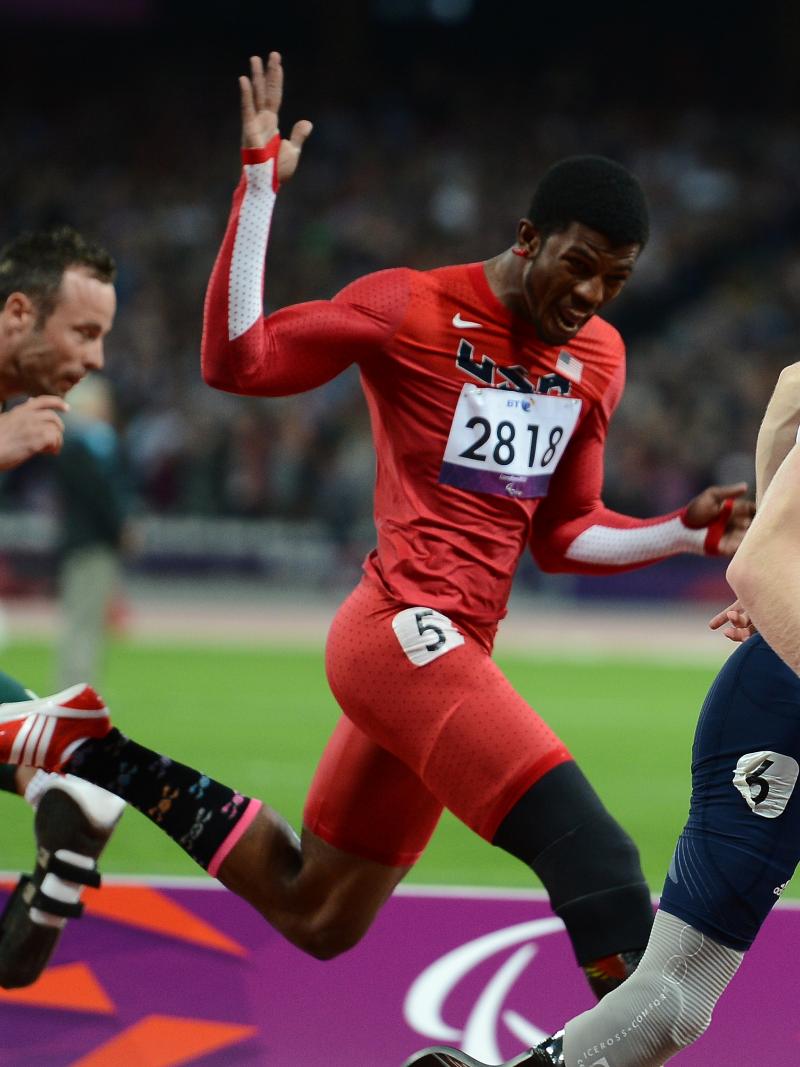 A picture of men running through a finishing line