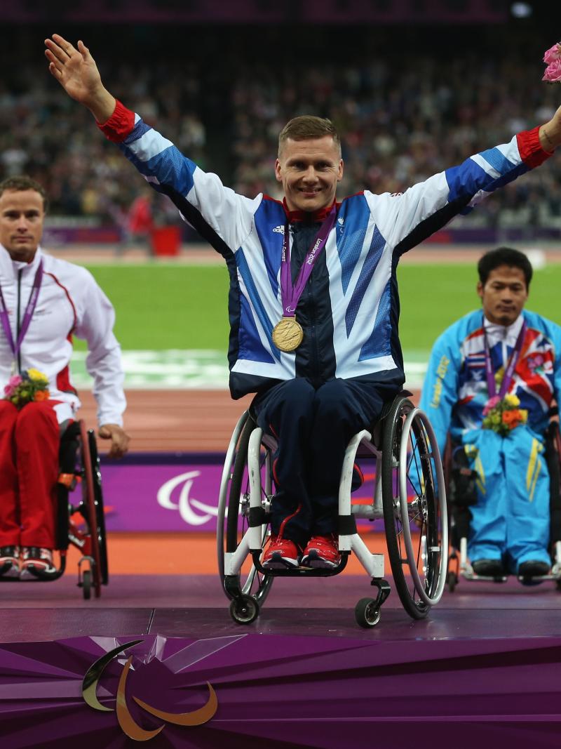 A picture of a men on a podium with medals around their neck