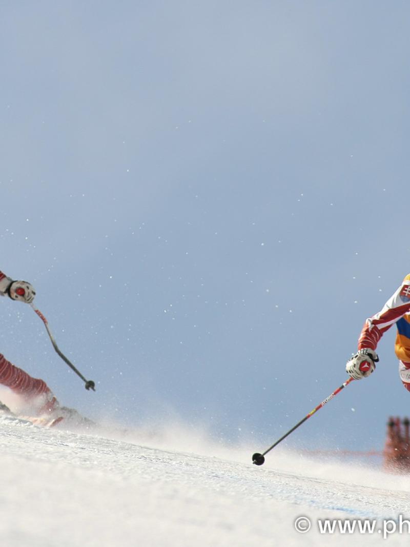 A picture of a woman skiing with her guide