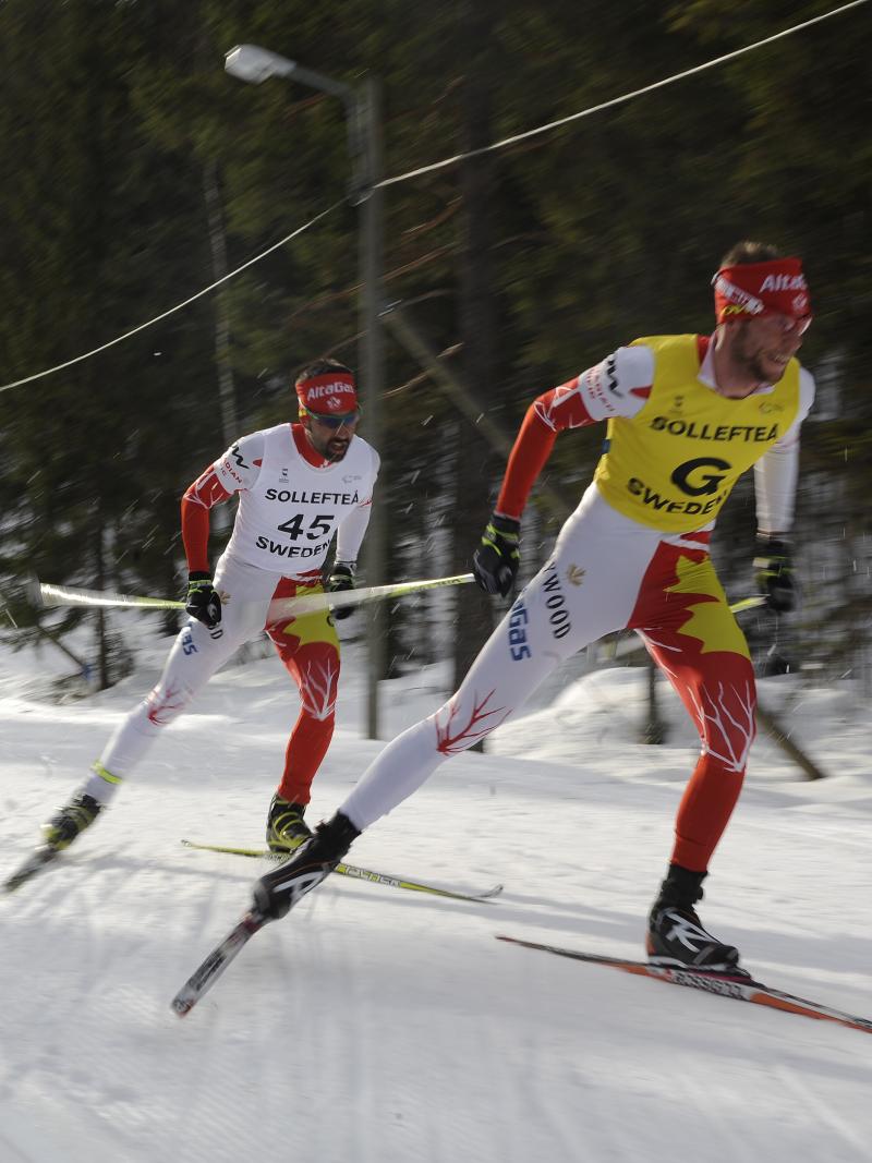 A picture of men skiing on a track