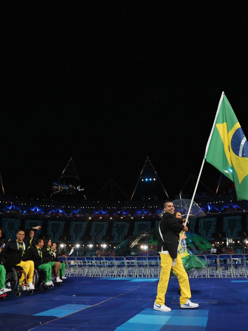 A picture of a man holding a brazilian flag
