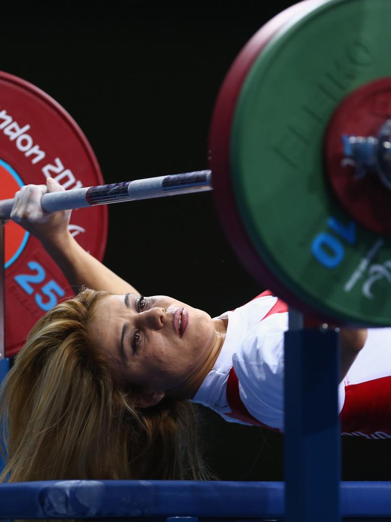 A picture of a powerlifter on a bench competing