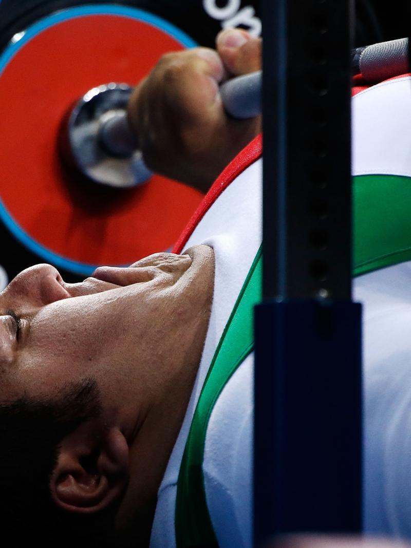 A picture of a powerlifter on a bench competing