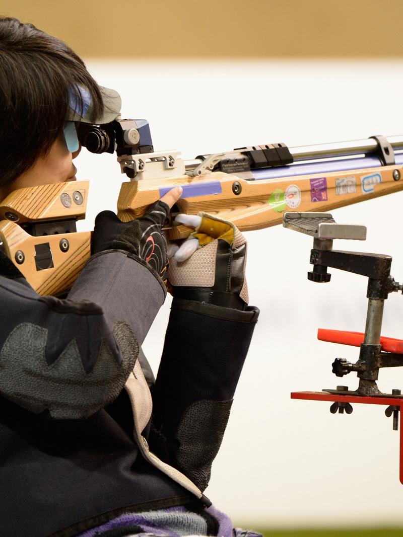 A picture of a woman competing in shooting